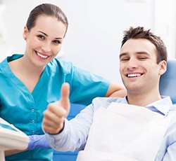 Man in dental chair giving thumbs up
