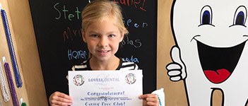 Child posing with certificate