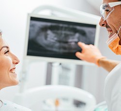 Dentist and patient looking at CT images