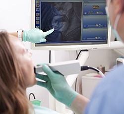 Dentist and patient looking at intraoral photos