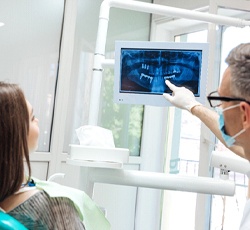 dentist showing a patient their X-rays