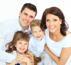 Smiling family portrait against a white background