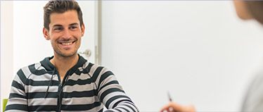 Smiling man at reception desk