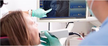 Woman and dentist looking at x-rays