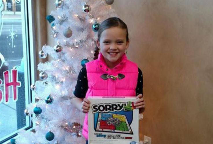 Young female patient in front of tree with sorry game