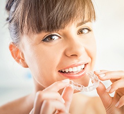 Woman placing clear aligner