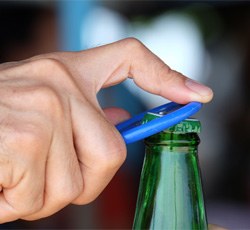 Man opening a bottle with bottle opener