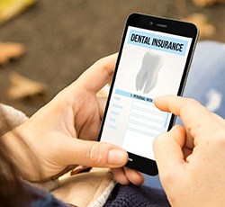 Patient looking at dental insurance information on phone