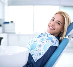 Smiling woman visiting emergency dentist in Lovell
