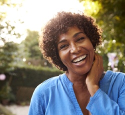 woman smiling brightly outdoors