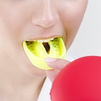 person wearing a yellow mouthguard