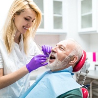 dental hygienist cleaning a patient’s teeth