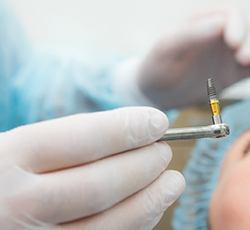 Dentist preparing to place dental implant in patient’s mouth