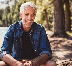 Confident senior man enjoying benefits of implant dentures