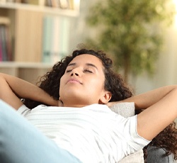 Woman resting after dental implant surgery in Lovell