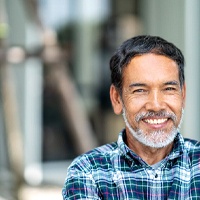 Man smiling after getting dental implants in Lovell