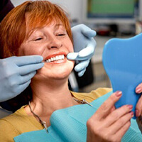 An older woman examining her smile