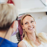 A patient smiling at her dentist