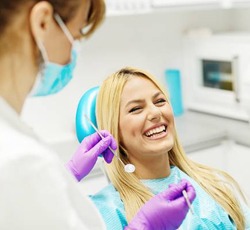 A smiling patient at her dental appointment