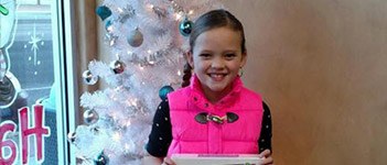 Child in front of christmas tree