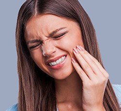 Woman holding jaw in pain