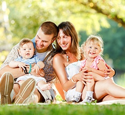 Family smiling at the park