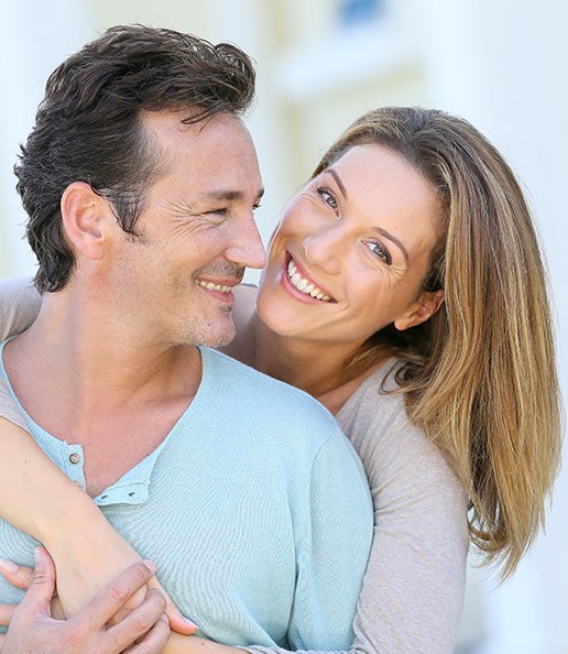 Smiling man and woman outdoors