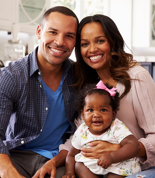 Smiling parents and daughter