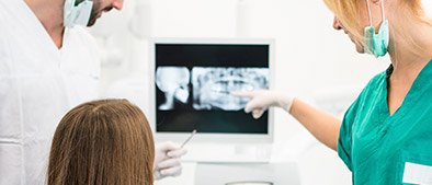 Dentist and patient looking at x-rays