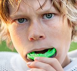 Teen boy placing sportsguard