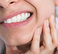 Woman holding jaw