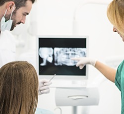 Dentist and patient looking at x-rays