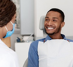 Patient smiles after getting porcelain veneers in Lovell