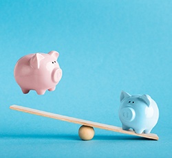 Piggy banks on balance scale