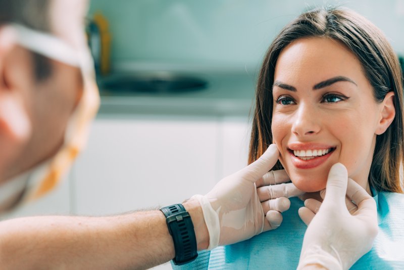 Dentist examining a patient’s dental implants in Lovell