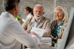 couple talking to their dentist about dental implants in Lovell 