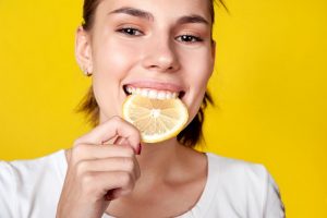 woman eating a lemon slice 