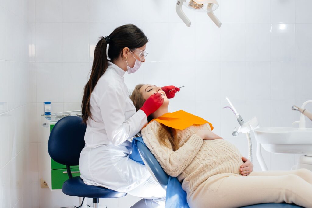 Pregnant woman in dental chair having exam