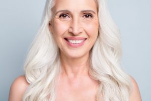 mature woman smiling with veneers 