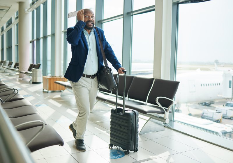 A man about to board a flight after tooth extraction