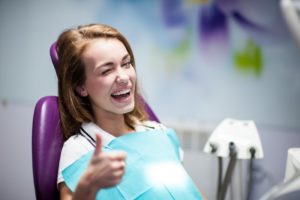 woman sitting in dentist chair smiling